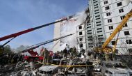 Rescuers work in the rubble of a damaged residential building in Uman, south of Kyiv on April 28, 2023, after Russian missile strikes targeted several Ukrainian cities overnight. Photo by Sergei SUPINSKY / AFP