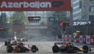 Red Bull Racing's Mexican driver Sergio Perez and Ferrari's Monegasque driver Charles Leclerc steer their cars during the sprint race ahead of the Formula One Azerbaijan Grand Prix at the Baku City Circuit in Baku on April 29, 2023. (Photo by Giuseppe CACACE / AFP)