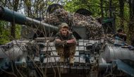 A Ukrainian serviceman sits on his tank at position near the frontline city of Bakhmut, Donetsk region on April 29, 2023, amid the Russian invasion of Ukraine. (Photo by Dimitar Dilkoff / AFP)