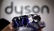FILE PHOTO: A Dyson employee shows a Dyson 360 Eye robot vacuum cleaner without its cover during the IFA Electronics show in Berlin September 4, 2014. REUTERS/Hannibal Hanschke/File Photo

