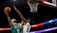 Derrick White #9 of the Boston Celtics takes a shot against Tyrese Maxey #0 of the Philadelphia 76ers during the second half of game two of the Eastern Conference Second Round Playoffs at TD Garden on May 03, 2023 in Boston, Massachusetts.  Maddie Meyer/Getty Images/AFP