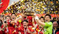 Urawa Red Diamonds players celebrate with the trophy after winning the AFC Champions League final against Al Hilal, yesterday. AFP