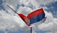 This photograph shows the Serbian flag at half mast in the village of Malo Orasje near the town of Mladenovac, about 60 kilometres (37 miles) south of Serbia's capital Belgrade, on May 6, 2023, in the aftermath of a drive-by shooting. (Photo by Andrej Isakovic / AFP)