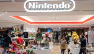 This photo taken on May 8, 2023 shows the logo (top) for Japanese gaming giant Nintendo at the entrance to company's official store in Tokyo's Shibuya district. Photo by Richard A. Brooks / AFP