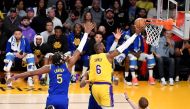 LeBron James #6 of the Los Angeles Lakers makes a layup against Kevon Looney #5 of the Golden State Warriors during Game Four of the Western Conference Semi-Finals of the 2023 NBA Playoffs at Crypto.com Arena on May 08, 2023 in Los Angeles, California.Photo by Allen Berezovsky /  AFP
