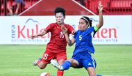 Vietnam's Nguyen Thi Bich Thuy (L) and Philippines' captain Hali Long (R) fight for the ball during the women's football match between Vietnam and Philippines at RSN Stadium during the 32nd Southeast Asian Games (SEA Games) in Phnom Penh on May 9, 2023. (Photo by NHAC NGUYEN / AFP)