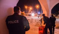 In this picture taken on May 9, 2023, police take positions near the Ghriba synagogue during a shootout on the resort island of Djerba. (Photo by Yassine MAHJOUB / AFP)