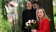 Italy's Prime Minister Giorgia Meloni holds a bouquet of flowers as she arrives to meet her Czech counterpart on May 10, 2023 in Prague, Czech Republic. (Photo by Michal Cizek / AFP)