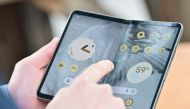 Members of the media view the new Google Pixel Fold phone during the Google I/O annual developers conference at Shoreline Amphitheatre in Mountain View, California on May 10, 2023. (Photo by Josh Edelson / AFP)
