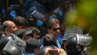 Policemen escort Pakistan's former Prime Minister Imran Khan (C) as he arrives at the high court in Islamabad on May 12, 2023. Photo by Aamir QURESHI / AFP