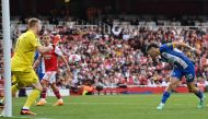Brighton's Paraguayan striker Julio Enciso (R) heads the ball and scores his team first goal during the English Premier League football match between Arsenal and Brighton and Hove Albion at the Emirates Stadium in London on May 14, 2023. (Photo by Glyn KIRK / AFP)