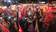 Supporters of Turkish President Tayyip Erdogan wave flags outside the AK Party headquarters after polls closed in Turkey's presidental and parliamentary elections in Ankara, Turkey. (Photo by Adem Altan / AFP)