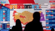 CHP members watch TV after the first results at the CHP building in Istanbul on May 14, 2023, after polls closed in Turkiye's presidential and parliamentary elections first round. Photo by Yasin AKGUL / AFP