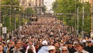 Thousands of protesters march during a rally to call for the resignation of top officials and curtailing violence in the media, after two mass shootings that killed 18 people earlier this month, in Belgrade, on May 19, 2023. (Photo by Andrej Isakovic / AFP)