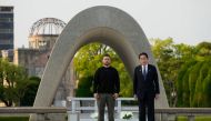 Japan's Prime Minister Fumio Kishida (R) and Ukraine's President Volodymyr Zelensky pose for a photo after laying wreaths in front of the Cenotaph for the Victims of the Atomic Bomb at the Hiroshima Peace Memorial Park in Hiroshima on May 21, 2023. (Photo by Eugene Hoshiko / POOL / AFP)