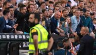 Real Madrid's Brazilian forward Vinicius Junior (R) confronts the public as he leaves after being sent off the pitch by the referee during the Spanish league football match between Valencia CF and Real Madrid CF at the Mestalla stadium in Valencia on May 21, 2023. (Photo by JOSE JORDAN / AFP)