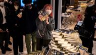 People line up to purchase the fresh copies of Japanese writer Haruki Murakami's new novella 
