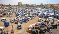Minivan buses and tuk-tuks (motorised rickshaws) wait for passengers at a bus station in Port Sudan on May 23, 2023. (Photo by AFP)