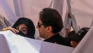 Former Pakistan prime minister Imran Khan with his wife Bushra Bibi arrive to appear at a high court in Lahore on May 15, 2023. (Photo by Arif Ali / AFP)