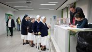 Nuns prepare to cast their ballots at a polling station in Madrid on May 28, 2023 during local and regional polls. (Photo by Oscar Del Pozo / AFP)