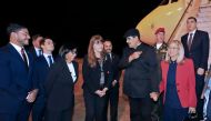 Handout picture released by the Venezuelan Presidency showing Venezuelan President Nicolas Maduro (2-R), his wife First Lady Cilia Flores, and Vice-President Delcy Rodiguez (3-L) being welcomed upon landing in Brasilia on May 28, 2023. (Photo by Zurimar CAMPOS / Venezuelan Presidency / AFP)