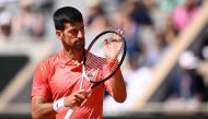 Serbia's Novak Djokovic applauds a point won by US Aleksandar Kovacevic during their men's singles match on day two of the Roland-Garros Open tennis tournament at the Court Philippe-Chatrier in Paris on May 29, 2023. (Photo by Emmanuel DUNAND / AFP)