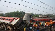 Rescue workers gather around damaged carriages during search for survivors at the accident site of a three-train collision near Balasore, about 200 km (125 miles) from the state capital Bhubaneswar in the eastern state of Odisha, on June 3, 2023. (Photo by Dibyangshu Sarkar / AFP)
