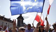 People wave the European and Polish flags during an anti-government demonstration organized by the opposition in Warsaw on June 4, 2023. (Photo by Wojtek Radwanski / AFP)