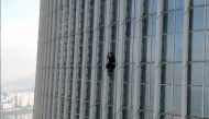 This handout photo taken on June 12, 2023 and provided by the Seoul Metropolitan Fire and Disaster Management Headquarters shows a man, identified by authorities as British, climbing the exterior of the 123-story Lotte World Tower in Seoul. (Photo by Handout / Seoul Metropolitan Fire and Disaster Management Headquarters / AFP) 