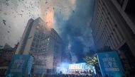 Manchester City's players celebrate on stage with their trophies following an open-top bus victory parade for their European Cup, FA Cup and Premier League victories, in Manchester, northern England on June 12, 2023. (Photo by Oli Scarff / AFP)