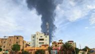 AFP file photo: Black smoke billows behind buildings amid ongoing fighting in Khartoum on June 9, 2023. 