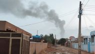 File photo: Smoke billows in the distance amid ongoing fighting in Khartoum on June 13, 2023. (Photo by AFP)