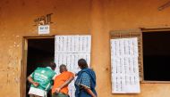 Voters look for their names on the voters roll at a polling station in Bamako on June 18, 2023 ahead of Mali's referendum vote. (Photo by OUSMANE MAKAVELI / AFP)