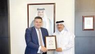 Chairman of Qatar Post Faleh Mohammed Al Nuaimi and Ambassador of Georgia to Qatar H E Nikoloz Revazishvili jointly presenting postage stamps.