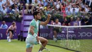 Spain's Carlos Alcaraz reacts after scoring a point against France's Arthur Rinderknech during their men's single tennis match on Day 4 of the Cinch ATP tennis Championships at Queen's Club in west London, on June 20, 2023. (Photo by Adrian DENNIS / AFP)