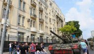 Members of Wagner group sit atop of a tank in a street in the city of Rostov-on-Don, on June 24, 2023. (Photo by STRINGER / AFP)