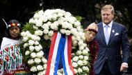 Netherlands' King Willem-Alexander (right) lays a wreath during the National Remembrance Day of Slavery in The Oosterpark, Amsterdam on July 1, 2023. (Photo by Remko de Waal / ANP / AFP)