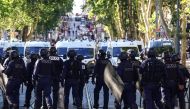 Police officers walk as they try to disperse protesters with tear gas during a demonstration against police in Marseille, southern France on July 1, 2023. (Photo by CLEMENT MAHOUDEAU / AFP)