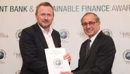 A QNB official receiving the award in London, recently.