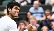Spain's Carlos Alcaraz celebrates winning against France's Jeremy Chardy during their men's singles tennis match on the second day of the 2023 Wimbledon Championships at The All England Tennis Club in Wimbledon, southwest London, on July 4, 2023. (Photo by SEBASTIEN BOZON / AFP)