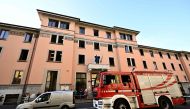 A firefighter vehicle is parked outside a retirement home after a Fire killed six residents, in Milan on July 7, 2023.  (Photo by GABRIEL BOUYS / AFP)