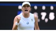 Poland's Iga Swiatek celebrates winning against Switzerland's Belinda Bencic during their women's singles tennis match on the seventh day of the 2023 Wimbledon Championships at The All England Tennis Club in Wimbledon, southwest London, on July 9, 2023. (Photo by Daniel Leal / AFP)