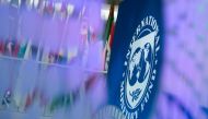 The International Monetary Fund (IMF) logo is displayed inside its headquarters in Washington, DC, on October 10, 2017. (Photo by Andrew Caballero-Reynolds / AFP)