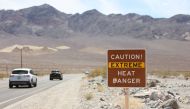 A heat advisory sign is shown along US highway 190 during a heat wave in Death Valley National Park in Death Valley, California, on July 16, 2023. (Photo by Ronda Churchill / AFP)