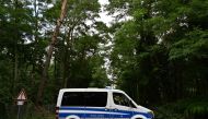 A police vehicle blocks a forest path during the search in the area for a wild animal on the loose, reportedly a lioness, on July 20, 2023 in Kleinmachnow, south-west of Berlin. Photo by John MACDOUGALL / AFP
