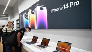 People look at MacBooks laptops during the first Apple Premium Reseller grand opening in Phnom Penh on July 15, 2023 (Photo by TANG CHHIN Sothy / AFP)