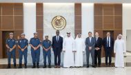 US Ambassador H E Timmy T Davis (fifth left) with Qatari and US officials during the workshop. 