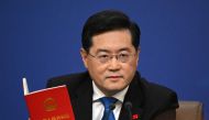 (Files) China's Foreign Minister Qin Gang holds a copy of China's constitution during a press conference at the Media Center of the National People's Congress (NPC) in Beijing on March 7, 2023. (Photo by Noel Celis / AFP)
