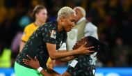Nigeria's defender #05 Onome Ebi (L) and Nigeria's defender #03 Osinachi Ohale celebrate their team's victory after the end of the Australia and New Zealand 2023 Women's World Cup Group B football match between Australia and Nigeria at Brisbane Stadium in Brisbane on July 27, 2023. (Photo by Patrick Hamilton / AFP)
