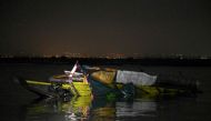 This photo shows a capsized wooden boat at Kalinawan Port Binangonan, Rizal province on July 27, 2023. Photo by JAM STA ROSA / AFP